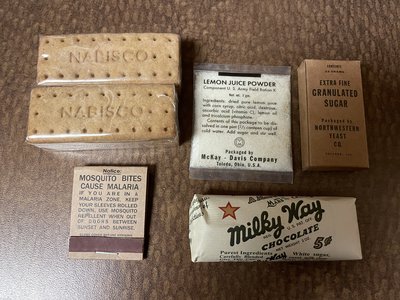 IMG_1189 - Copy.JPG (3.79 MiB) Viewed 18424 times Inside the cellophane wrap (and the manufacture claims it is in fact real cellophane) were two packages of biscuits, lemon juice powder, granulated sugar, matches and a Milky Way bar.