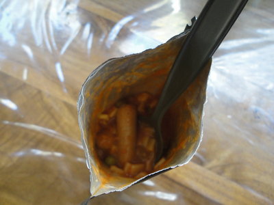 Brekkie is ready. Smells good, looks good<br />Signs of peas, the odd bit of carrot, maybe corn and some unidentifiable white stuff on the veggie side, and some real sausages (unsure of type by appearance). <br />Appears to be in a tomato sauce