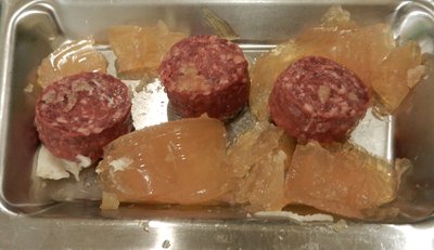 I set three beef medallions free from the gelatin