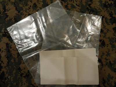 Some trash bags, one with handle one with out and tissues