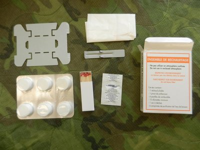 Folding stove, 6 Hex tablets, Trash bag, Matches, Water tablets, and a entree holder